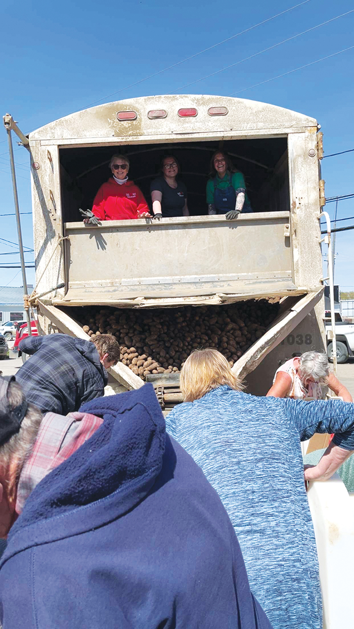Beryl Stewart, Sam Campbell and Katie Hepp with Second Harvest in the back of the potato truck that malfunctioned. “I really cherish the memory of that day. Such a wonderful community you guys have, truly,” says Katie Hepp.